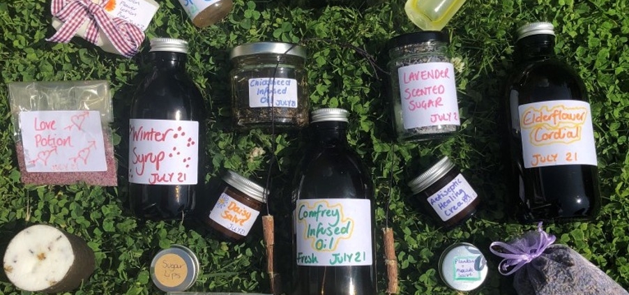 A photo showing different herbal remedies made at the Junior Herbalist Club. The home-made remedies include creams, ointments, syrups, soaps and cough drops.