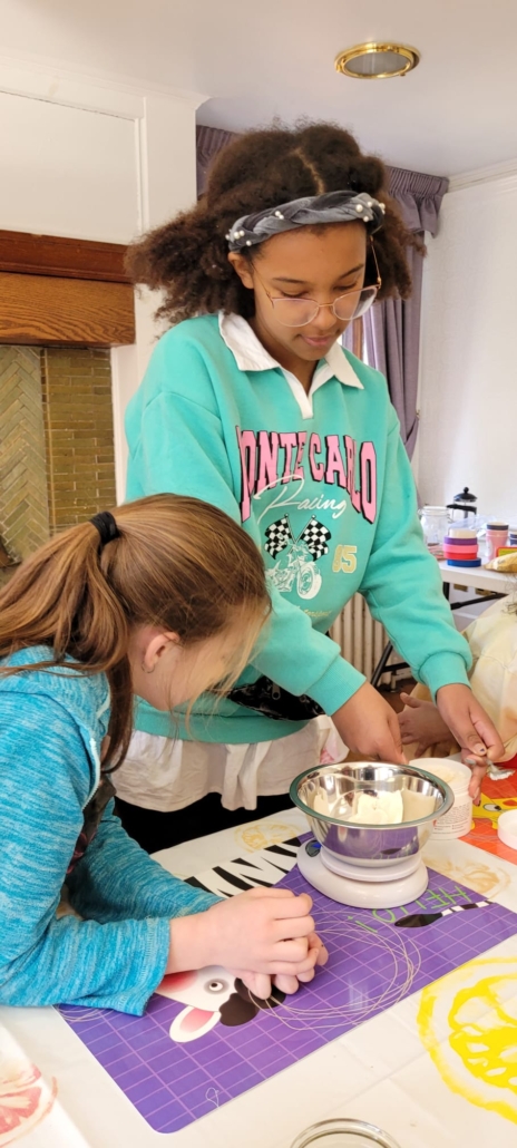 Children at the Junior Herbalist Club weighing out ingredients to make Dandelion Moisturising Bars